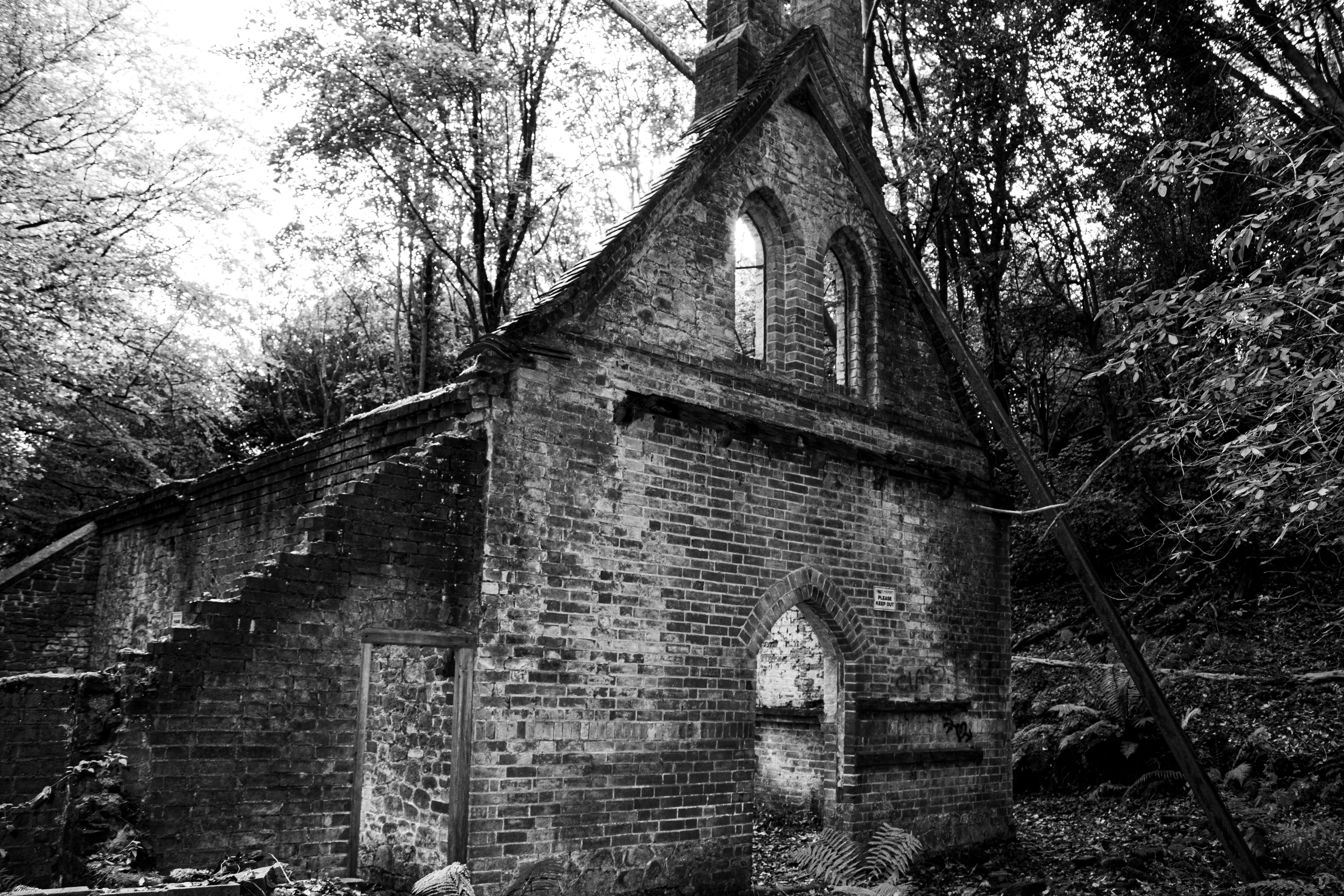 Bedham Church exterior, flint walls in forest